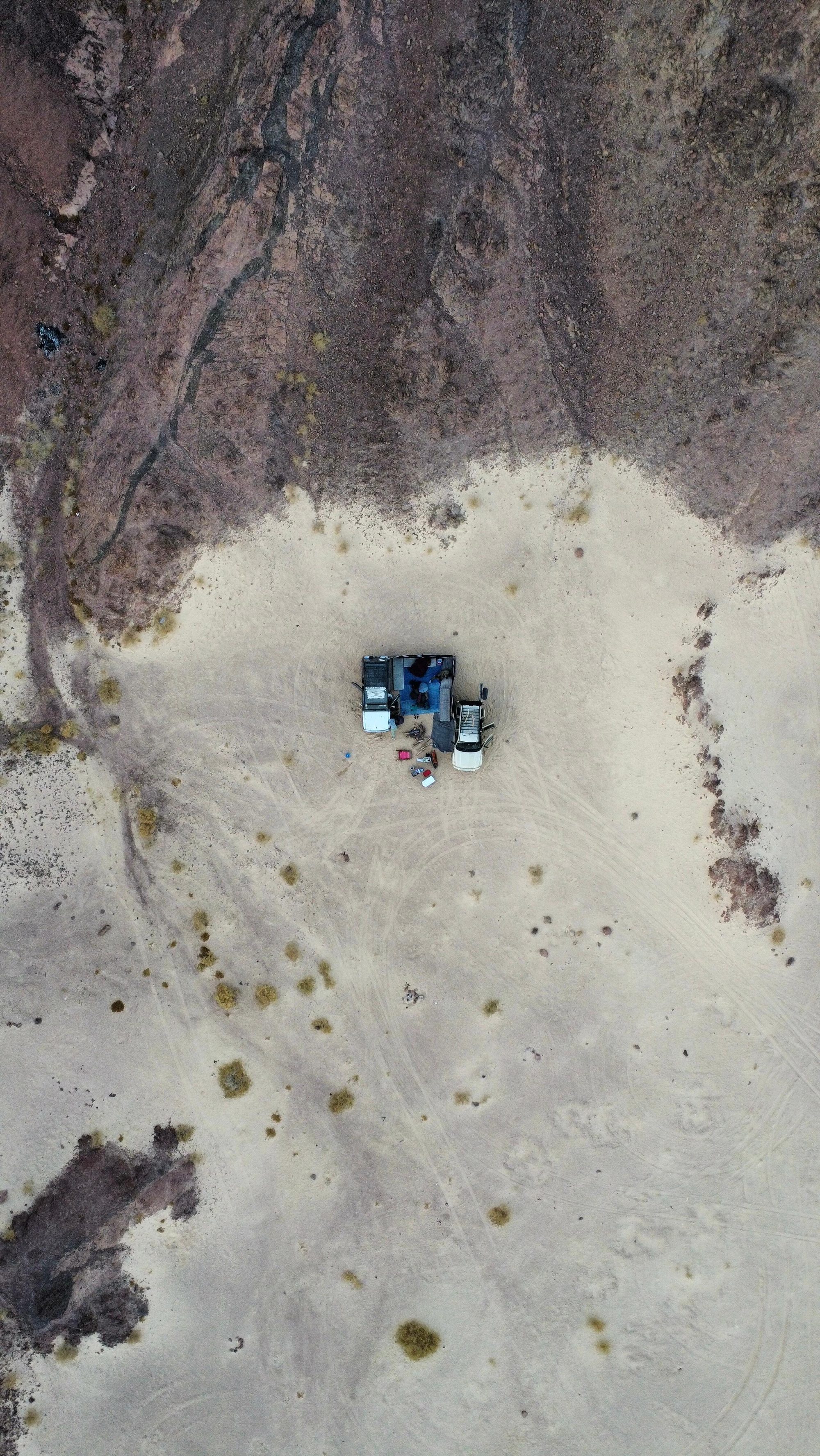 Drone shot — tiny camp in vast desert