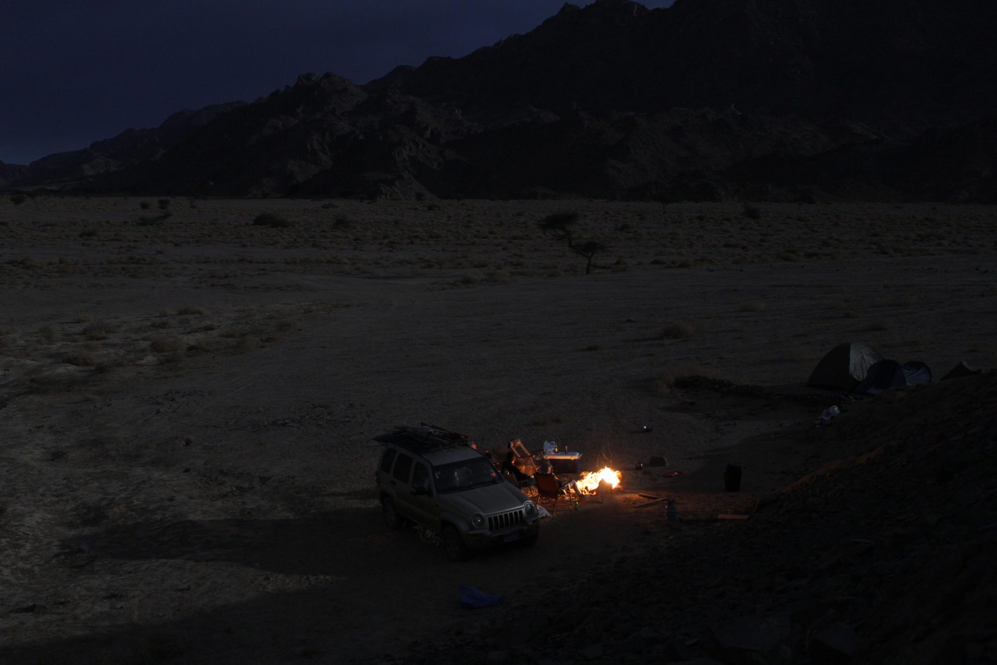 Night camp fire in the desert